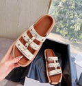 Women's retro Roman sandal slippers in patent leather finish showing strap design