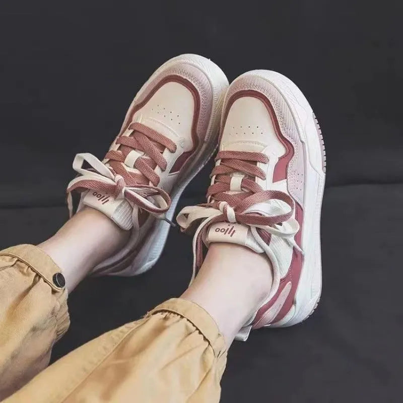 Beige and pink low-top sneaker with a height-increasing rubber sole on a white background