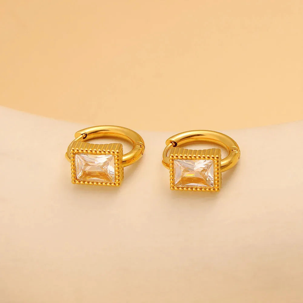 Square stainless steel earrings with round ring design elements in white, black and green colour options