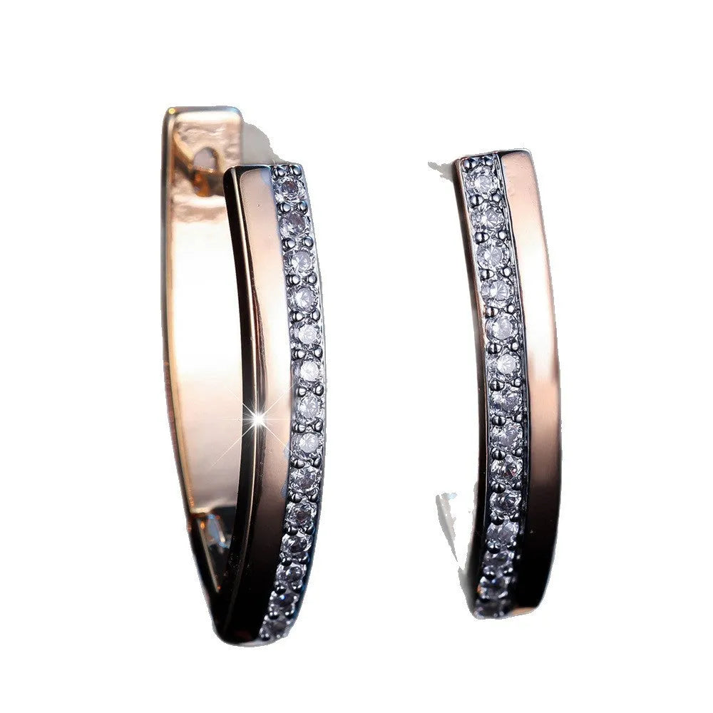 Women's V-shaped geometric copper ear clips in champagne gold with white diamond accents