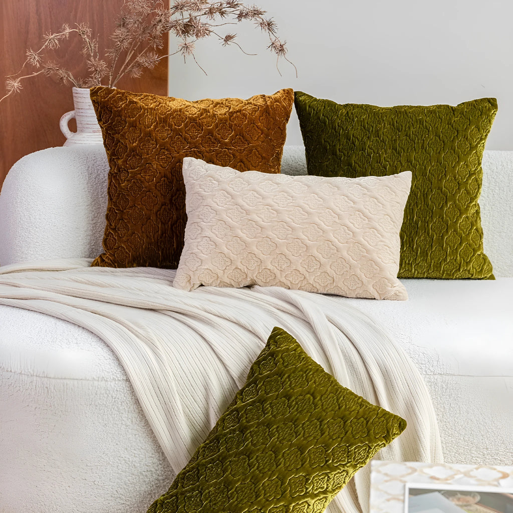 Brown gold antique-style quilted square cushion pillow with three-dimensional texture on a chair.