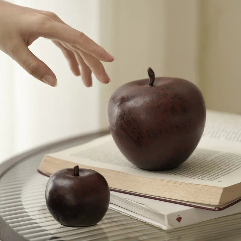 Retro Chinese style ceramic simulation apple ornament for desktop decoration on a wooden surface.