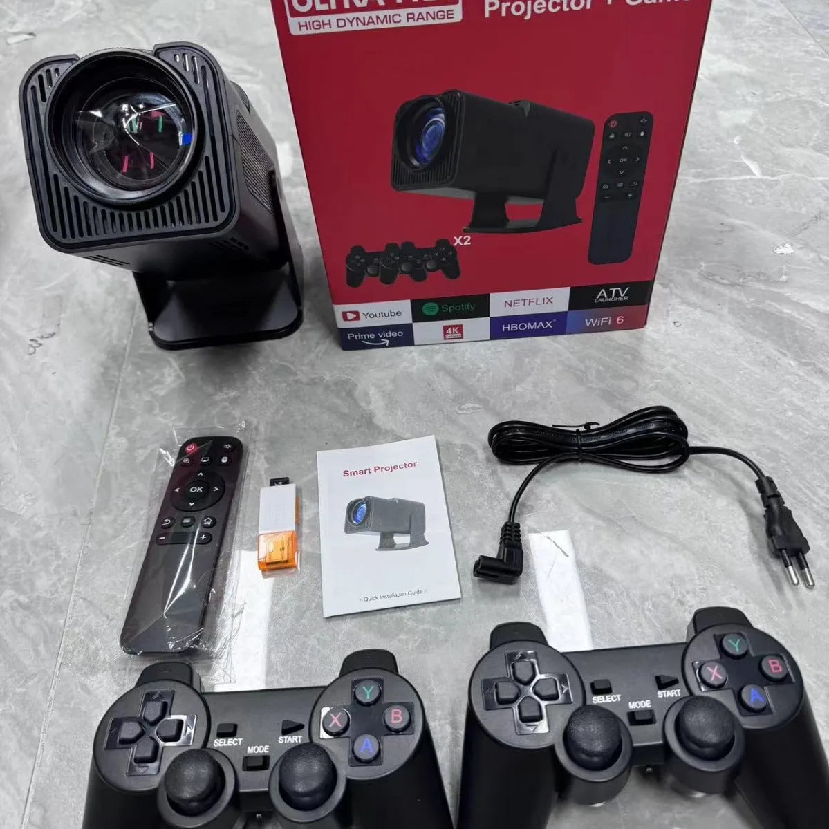 A wireless home projector with a carrying handle, displaying a bright game or movie on a wall.