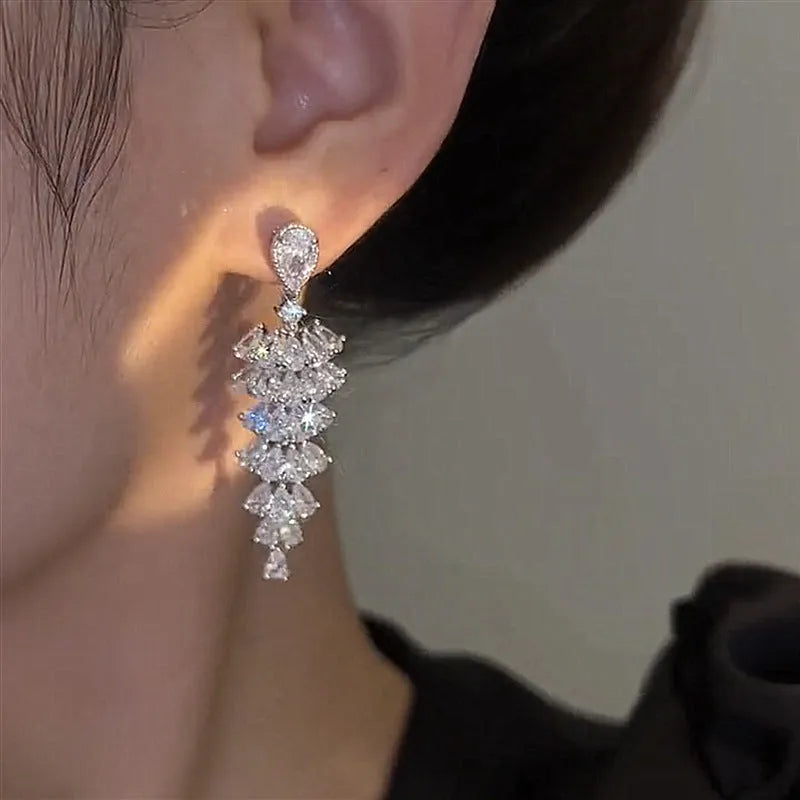 Pair of silver-coloured Christmas tree drop earrings with pagoda shape on stud fastenings.