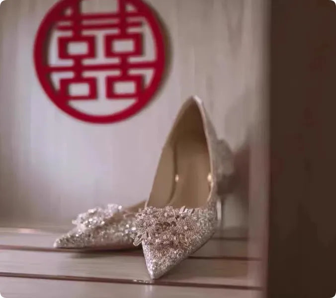Champagne coloured bridal shoes with crystal rhinestones, pointed toe, and court heel.
