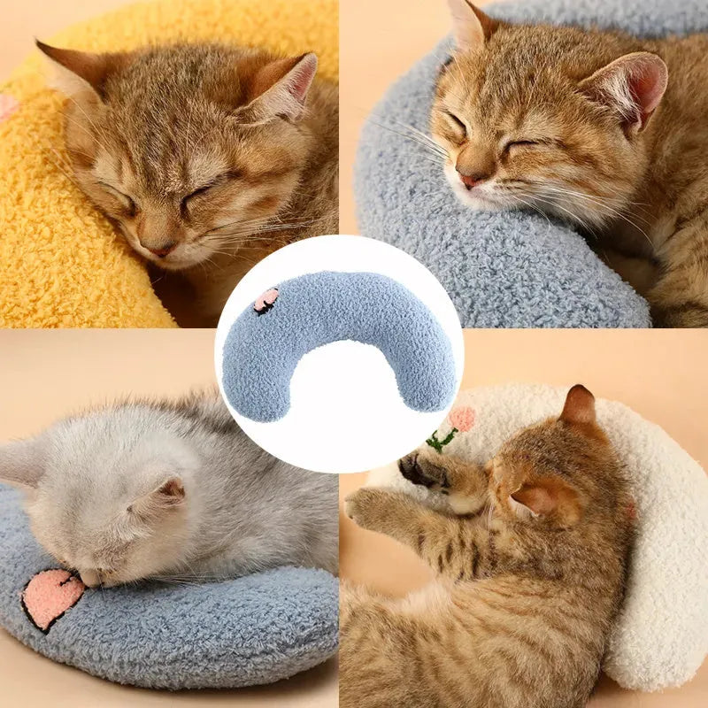 Small half-donut shaped pet pillow in blue faux fur, showing quilted texture and plush filling.