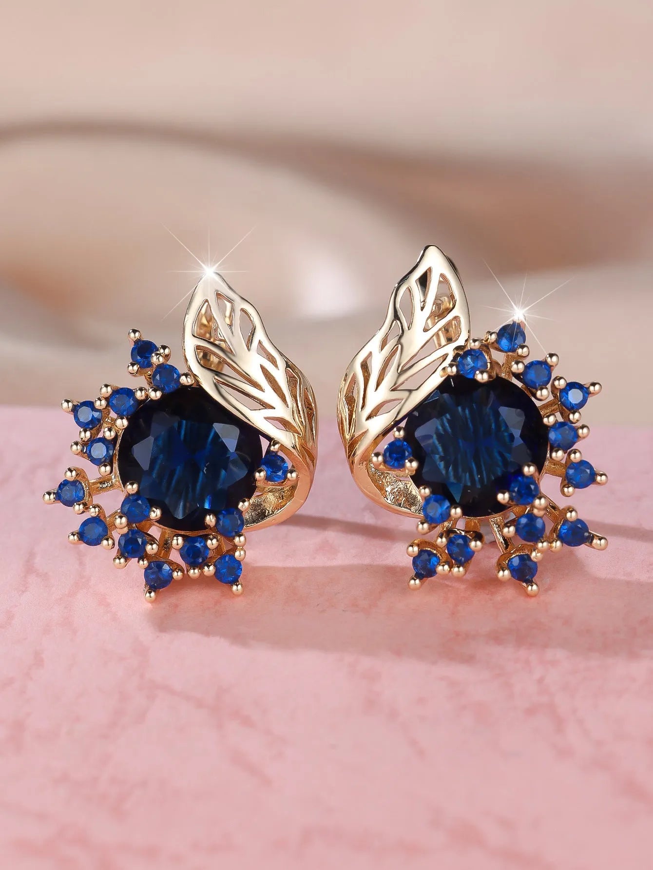 Round flower feather earrings with zircon stones in champagne gold finish, showing six colour variations