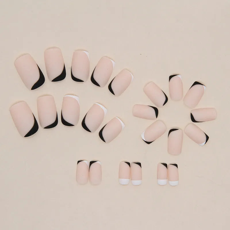 Black and white frosted French style false nails with mandarin duck colour contrast on plastic wearable armour.