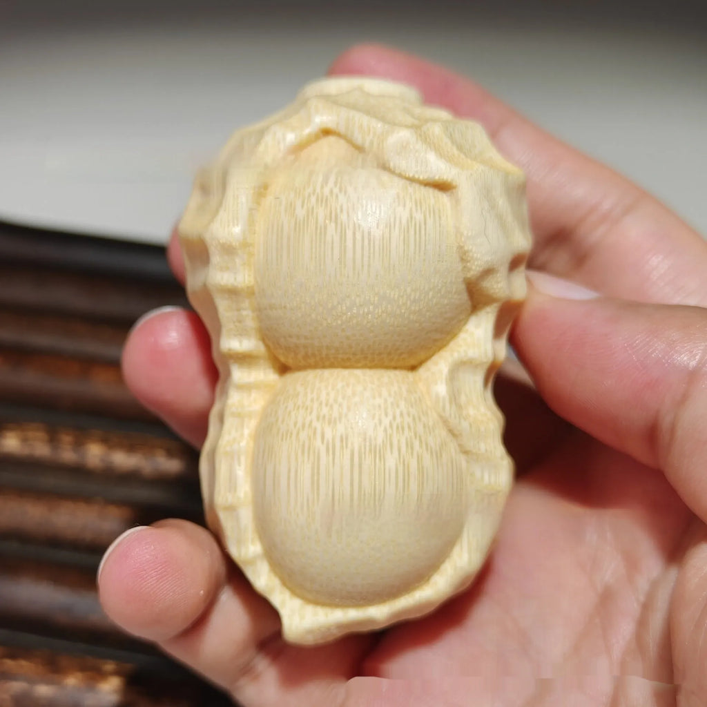 Solid bamboo carved peanut ornament with modern simplicity style and symbolic message.