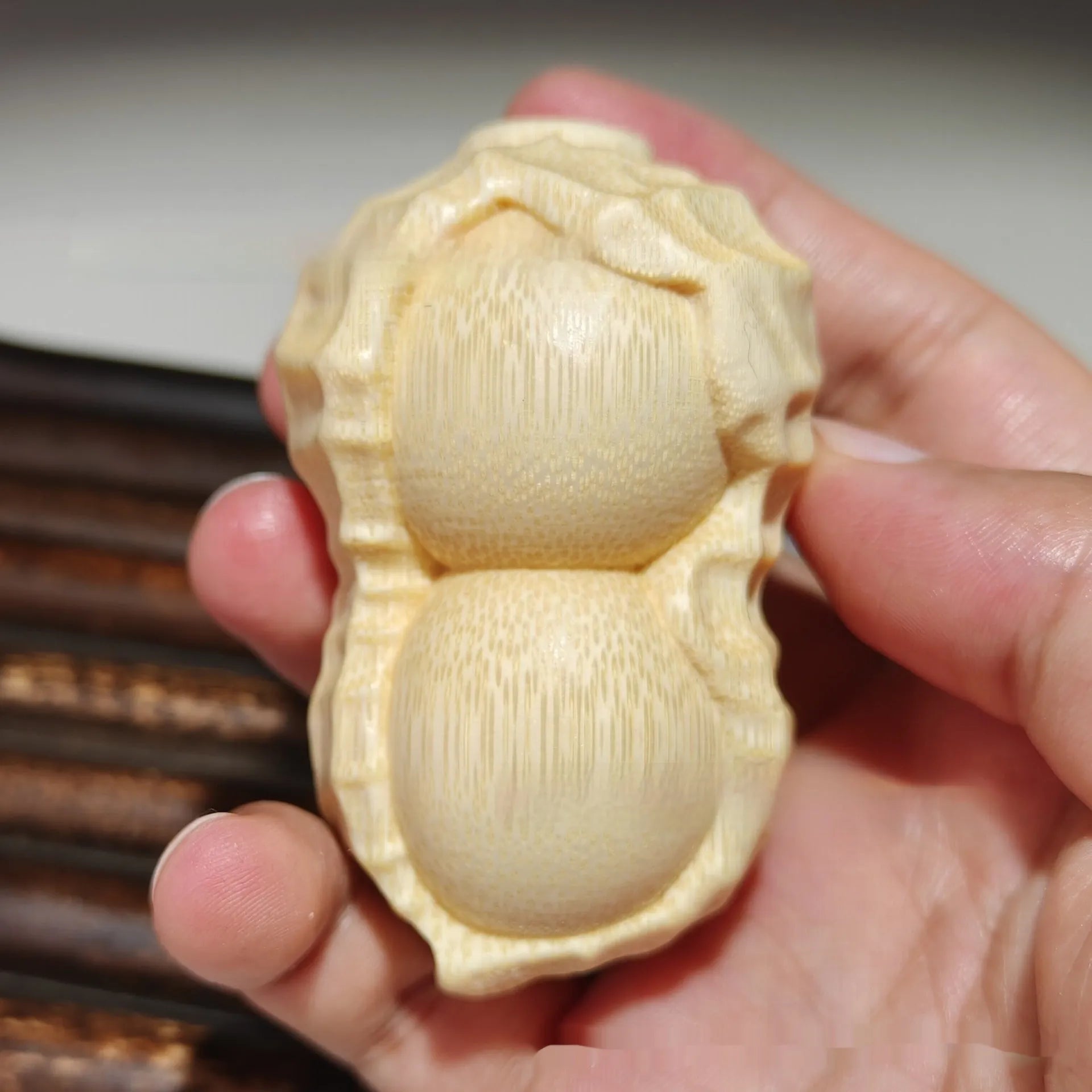 Solid bamboo carved peanut ornament with modern simplicity style and symbolic message.