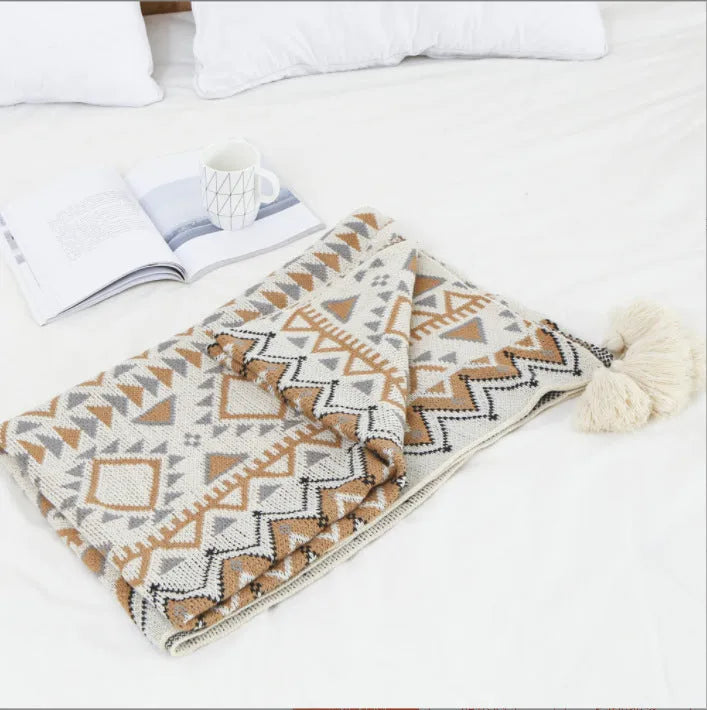 Bohemian style acrylic sofa throw blanket with tassel trim in a geometric pattern colour