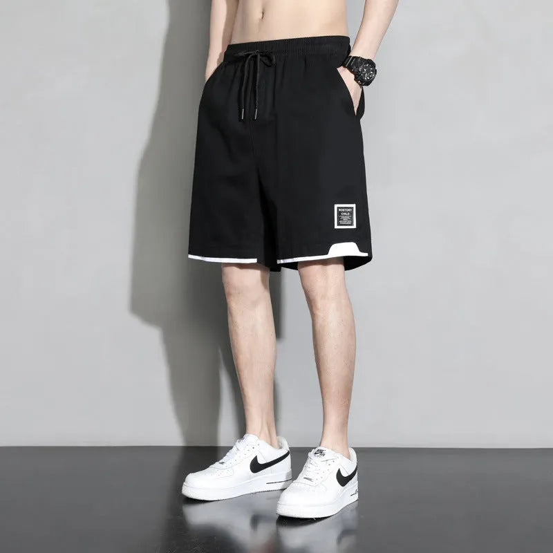 Boys' plus size cotton shorts in black, shown flat, featuring a mid waist and shorts length design.