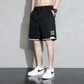 Boys' plus size cotton shorts in black, shown flat, featuring a mid waist and shorts length design.