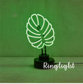 White tube bamboo shape desktop lamp emitting green light, with USB cable.