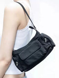 Black women's shoulder bag with double pockets and crossbody strap showing side line detailing