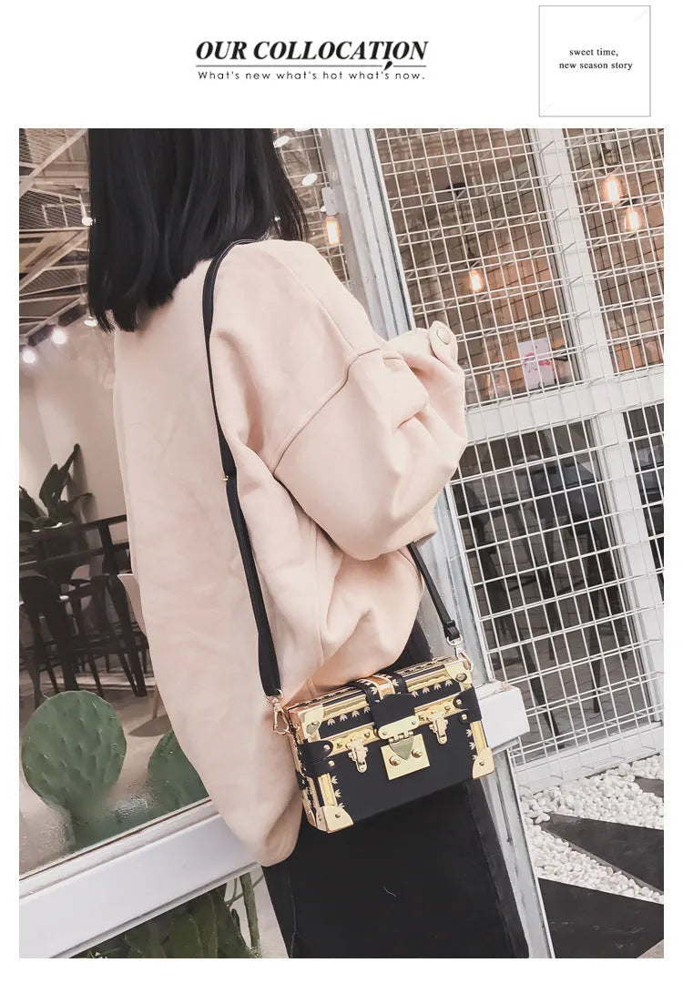 Women's hard black PU shoulder bag with flap, hasp closure, and rivet detail on a solid background.