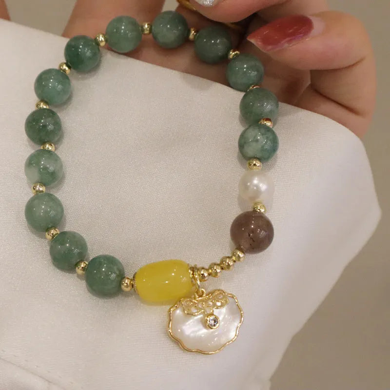 Natural green jade shell bracelet on a woman's wrist, casual style
