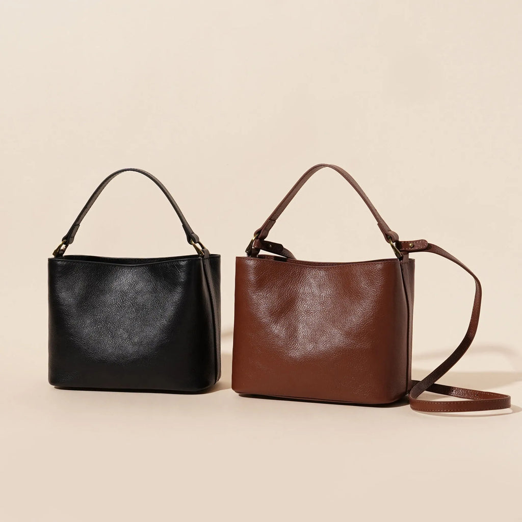 Sugar brown genuine leather women's shoulder handbag with sewing thread detailing on a white background