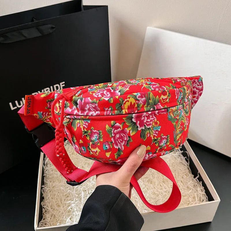 Women's nylon waist bag with big floral pattern, contrast stitching, and three-dimensional outer pocket in black