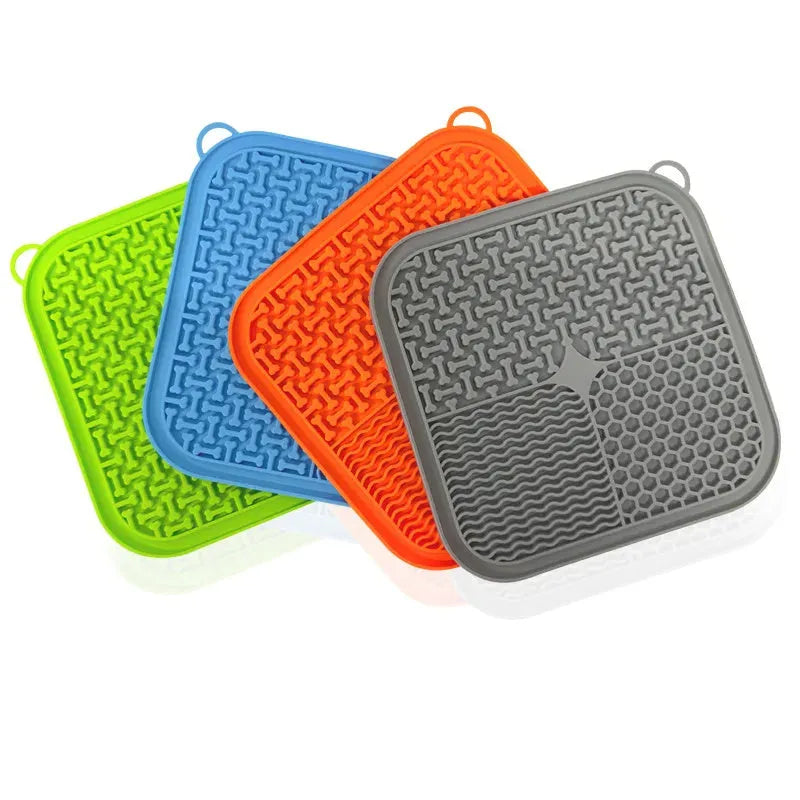 Blue silicone dog licking mat with textured surface and suction cups on back