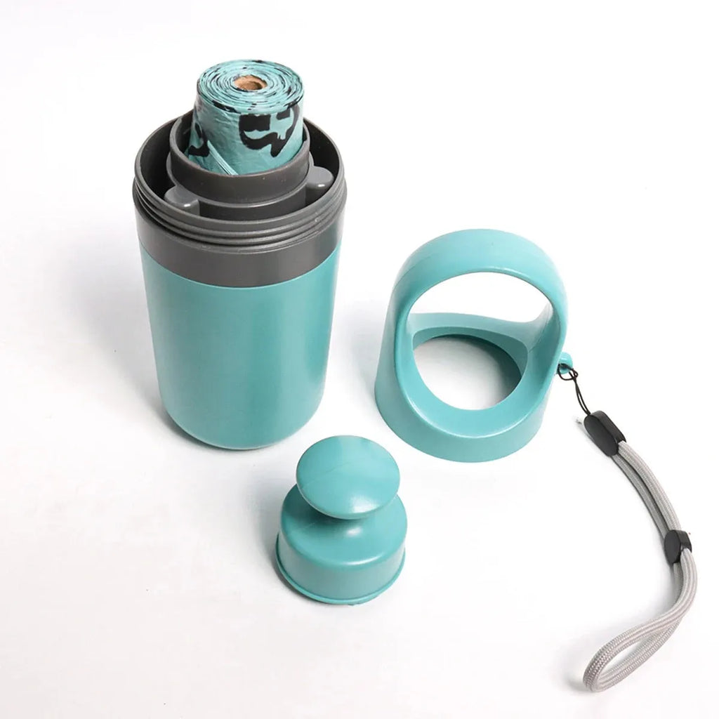 Blue dog pooper scooper with claw mechanism and bag dispenser on grass