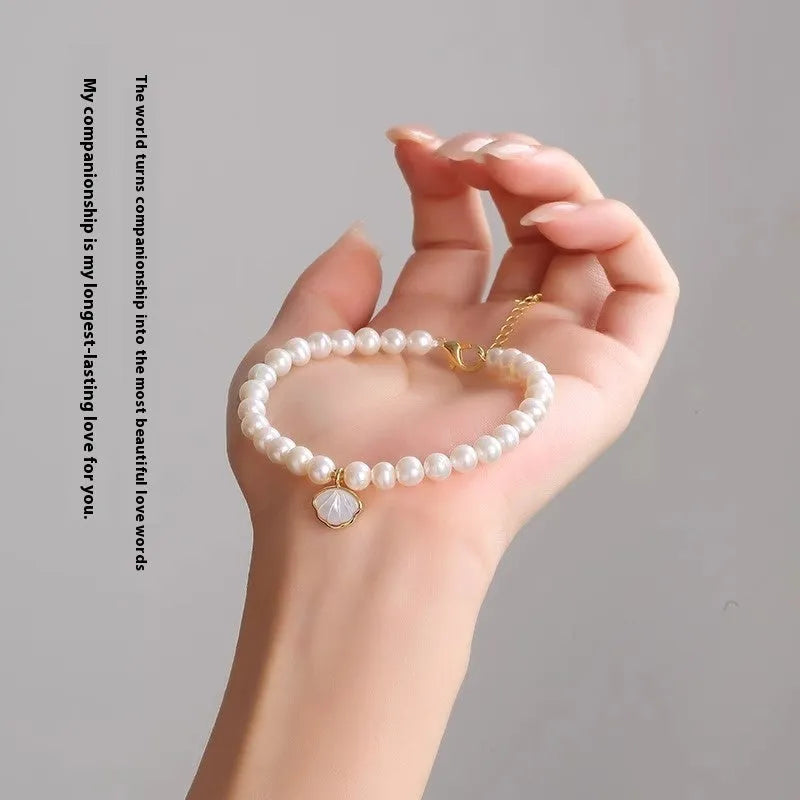 Women's freshwater pearl bracelet with fan-shaped pearl cluster and choice of elastic or chain fastening.