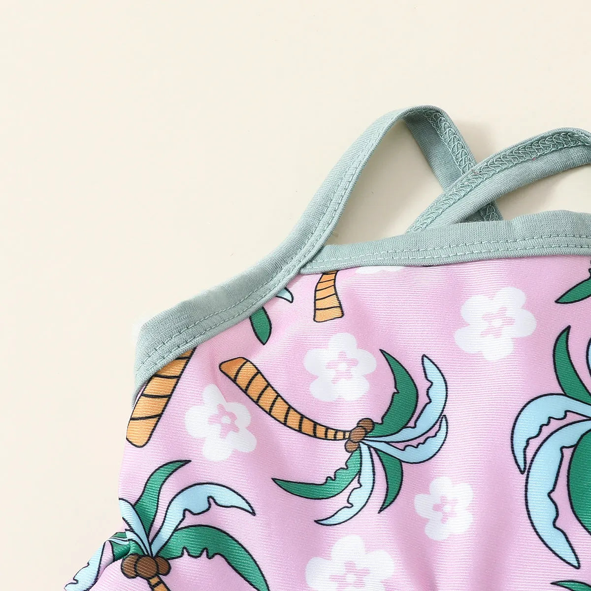 White two-piece toddler swimsuit set with a top and matching shorts on a hanger.