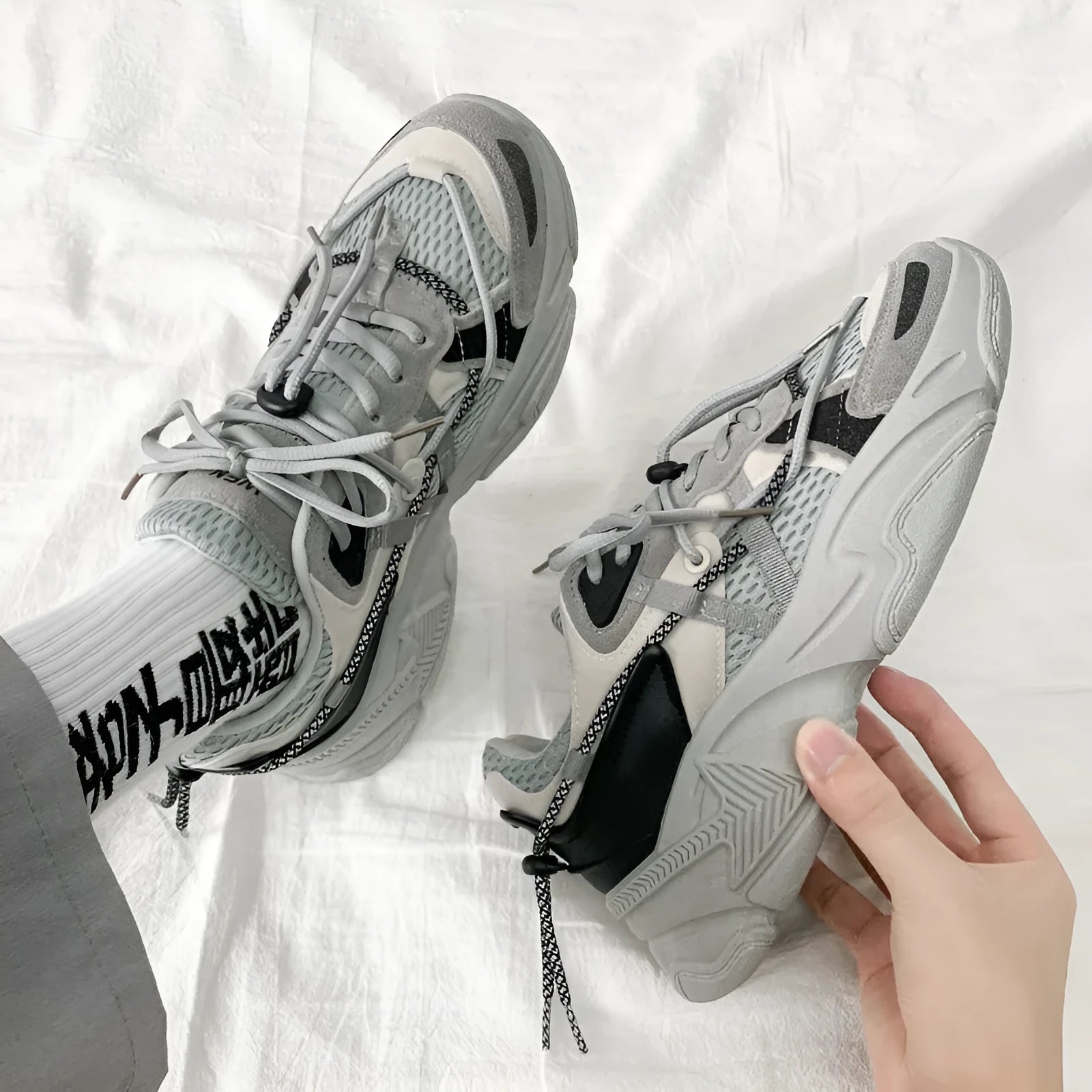 Men's white, black, and grey platform dad shoes with thick soles and lace-up front.