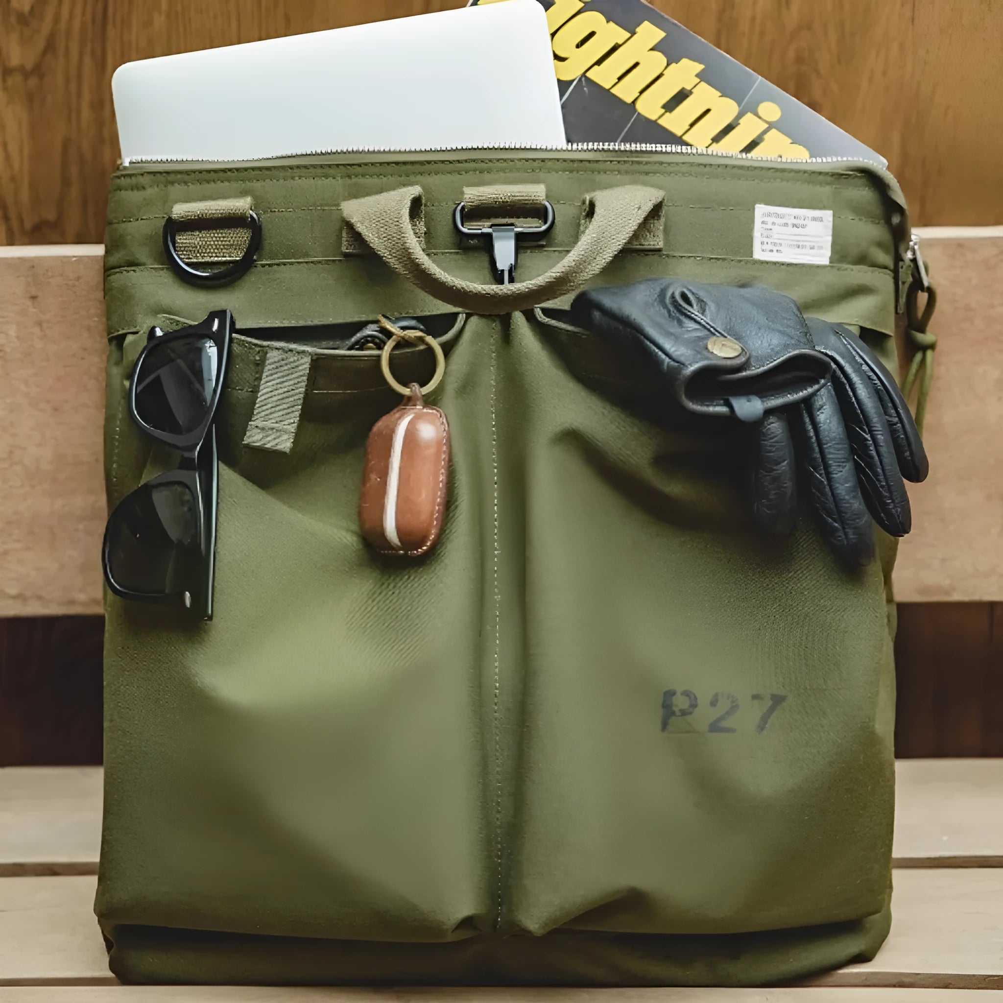 Canvas messenger bag in military green with shoulder strap and laptop compartment