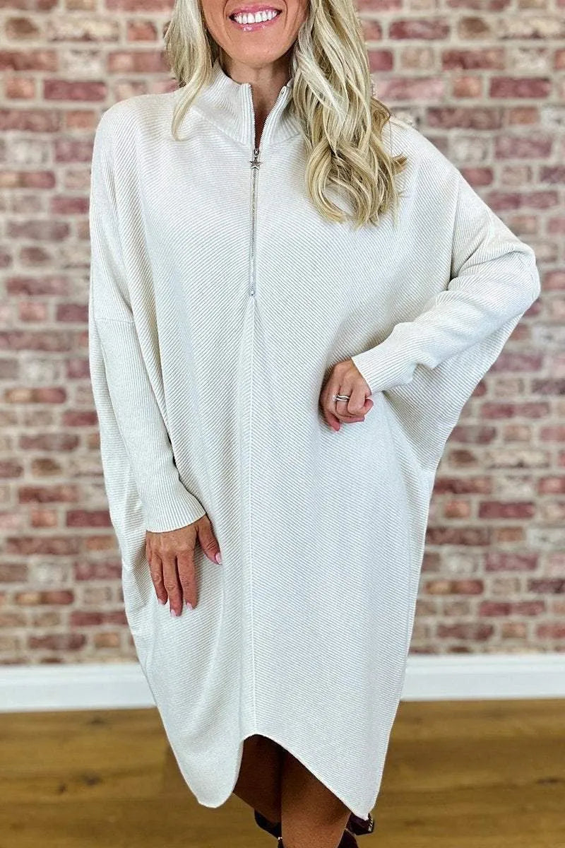 Women's solid colour loose knitted dress with a zipper detail on a hanger.