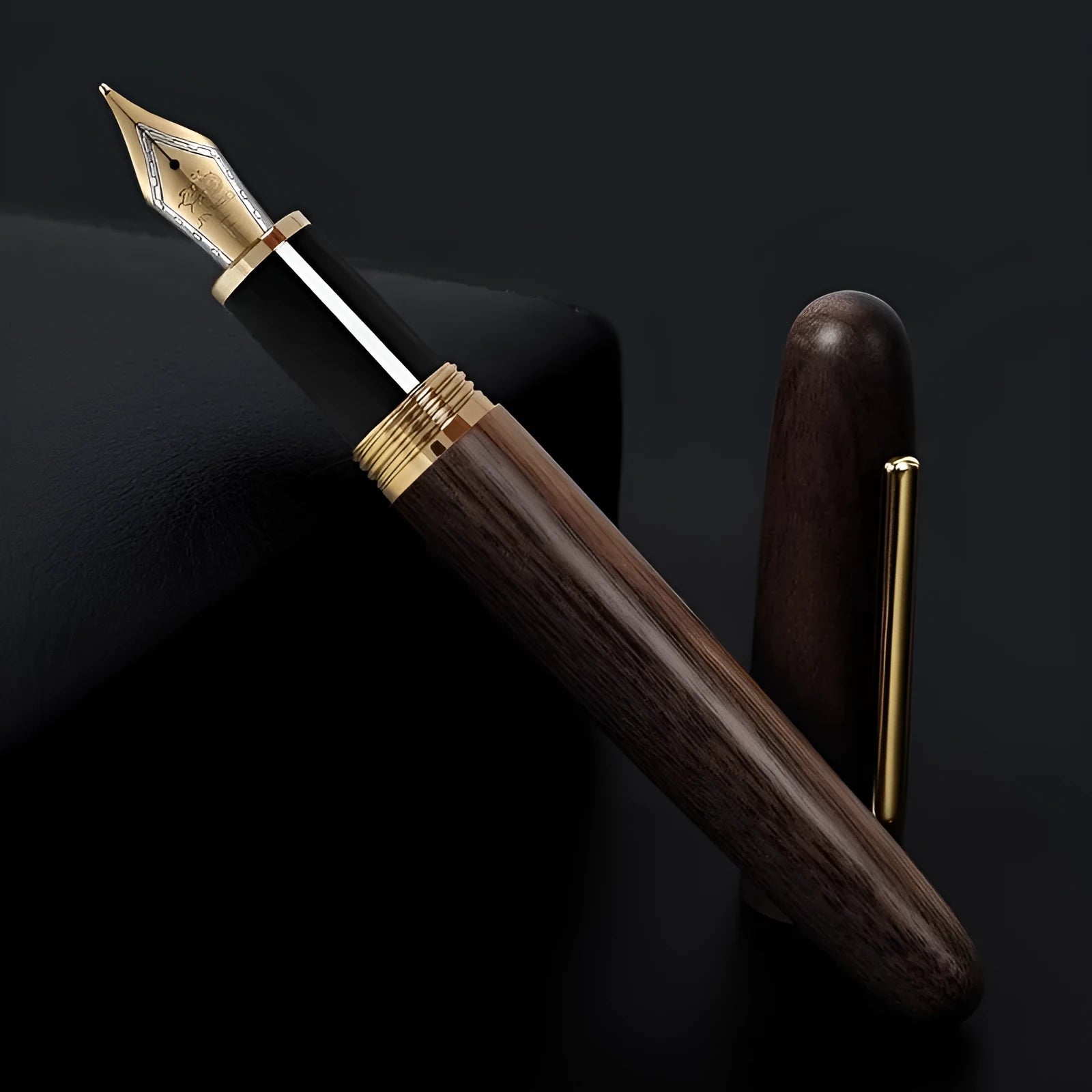 Wooden fountain pen with a rotating cap shown alongside nib options on a desk.