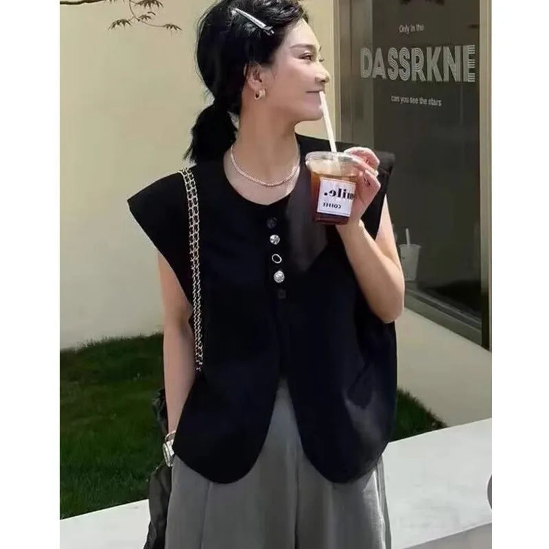 Women's loose-fit sleeveless polyester vest in black with visible pocket detail on the front.