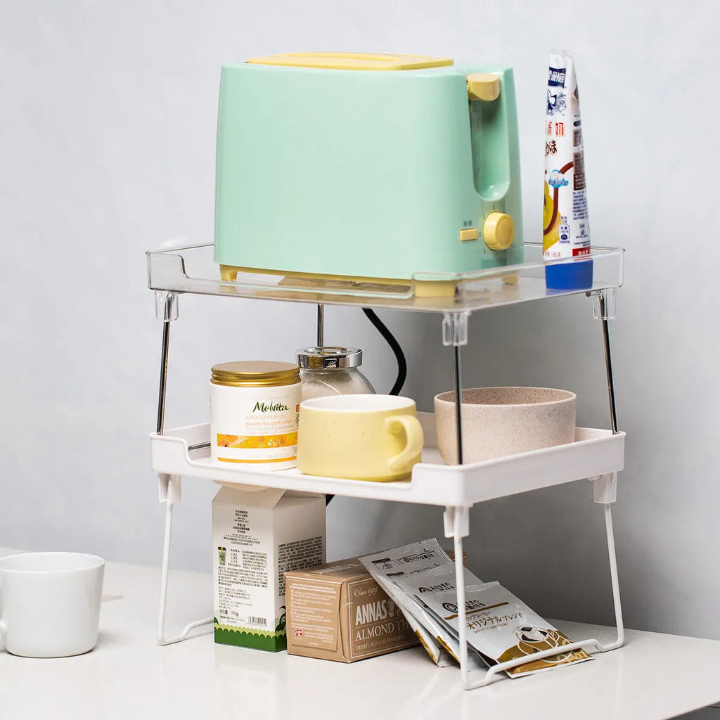 Plastic kitchen supplies rack in transparent colour on a countertop holding spice jars and small bottles