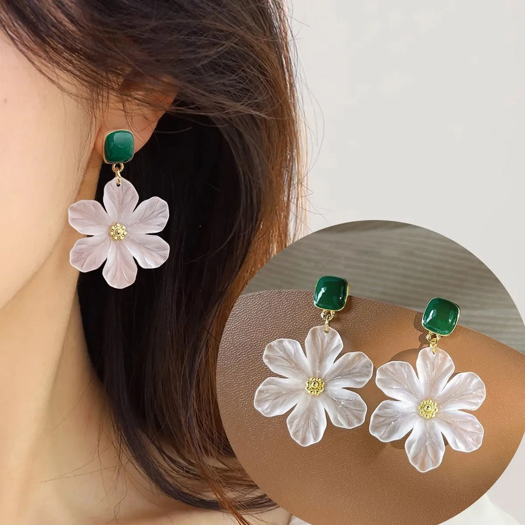 A pair of dark green alloy earrings with a sweet needle flower design on a white background.
