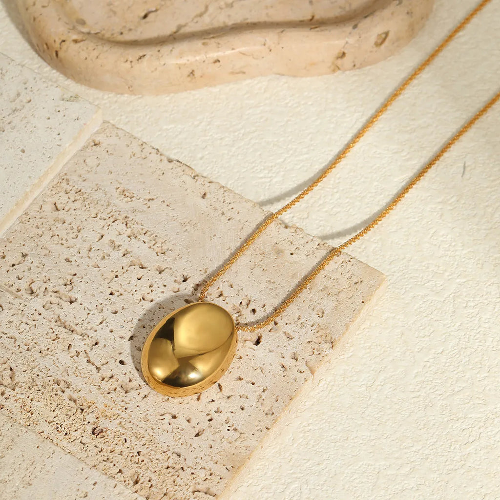 18K gold-plated geometric pendant on an adjustable stainless steel necklace chain.