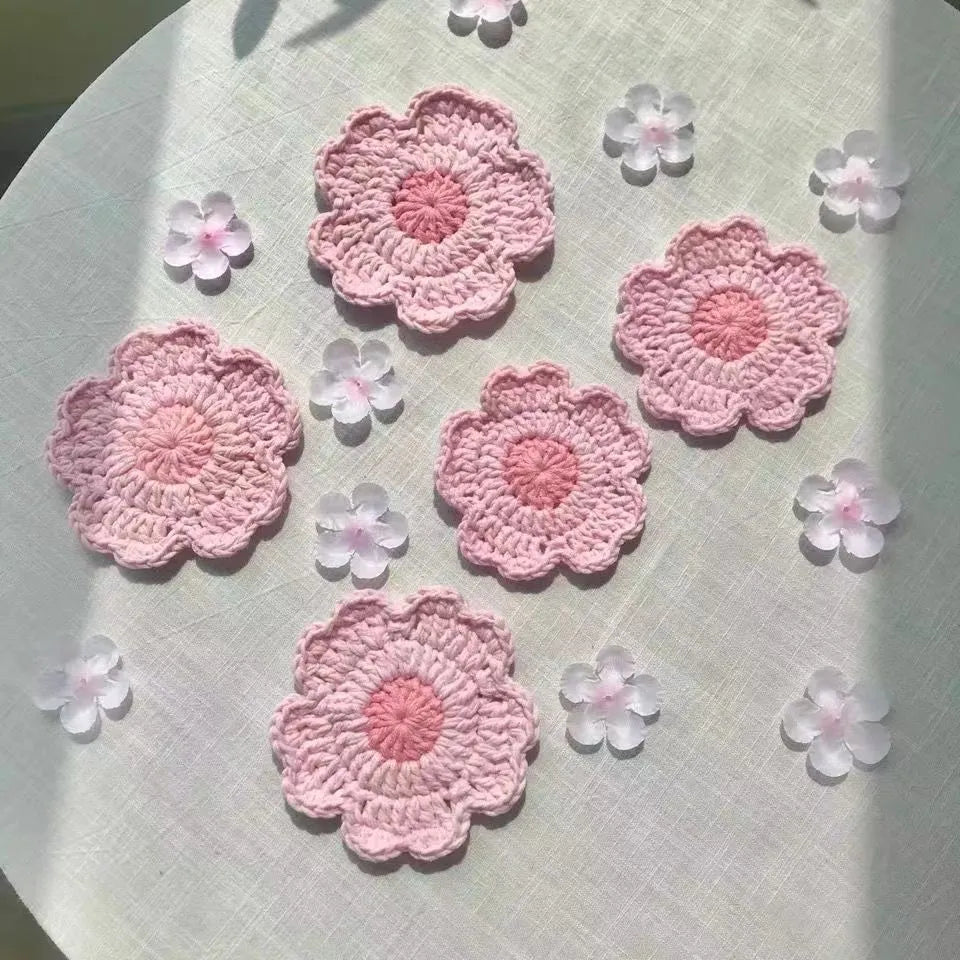 Hand-woven finished wool coaster on a wooden table surface
