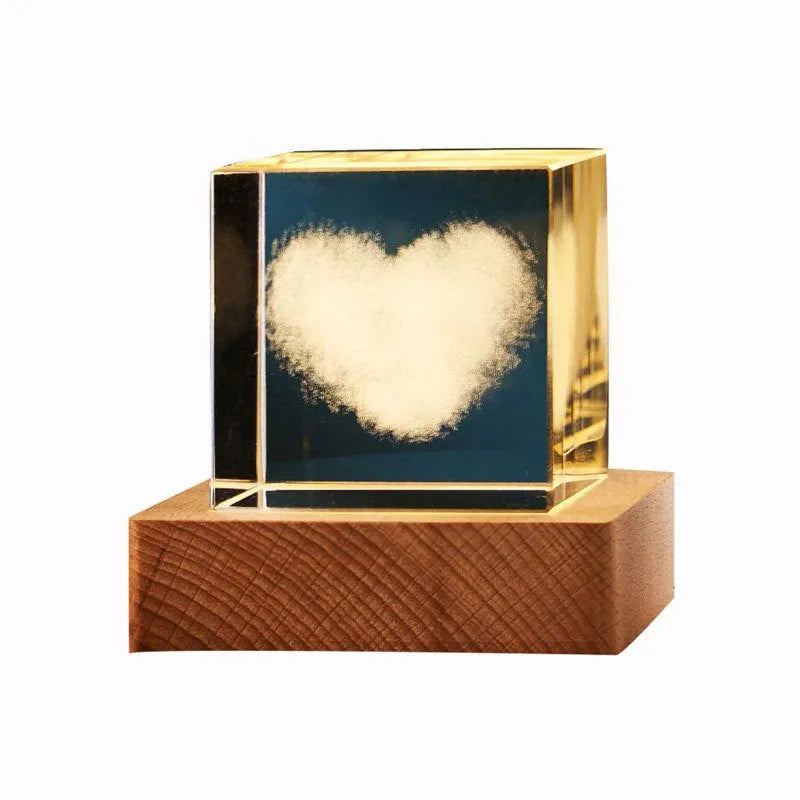 3D transparent crystal cube night lamp with warm light pattern on wooden desktop