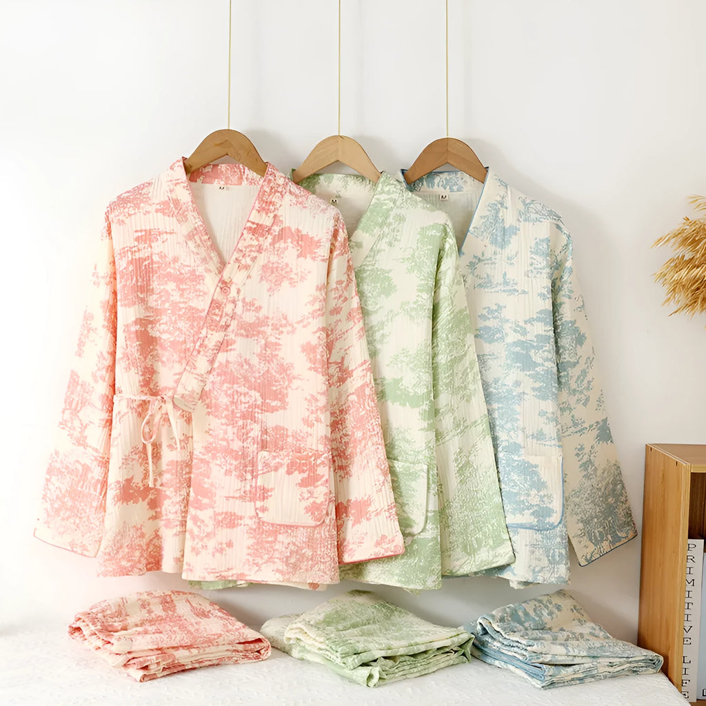 Women's pink cotton gauze lounge suit set with long sleeve top and trousers on a hanger.