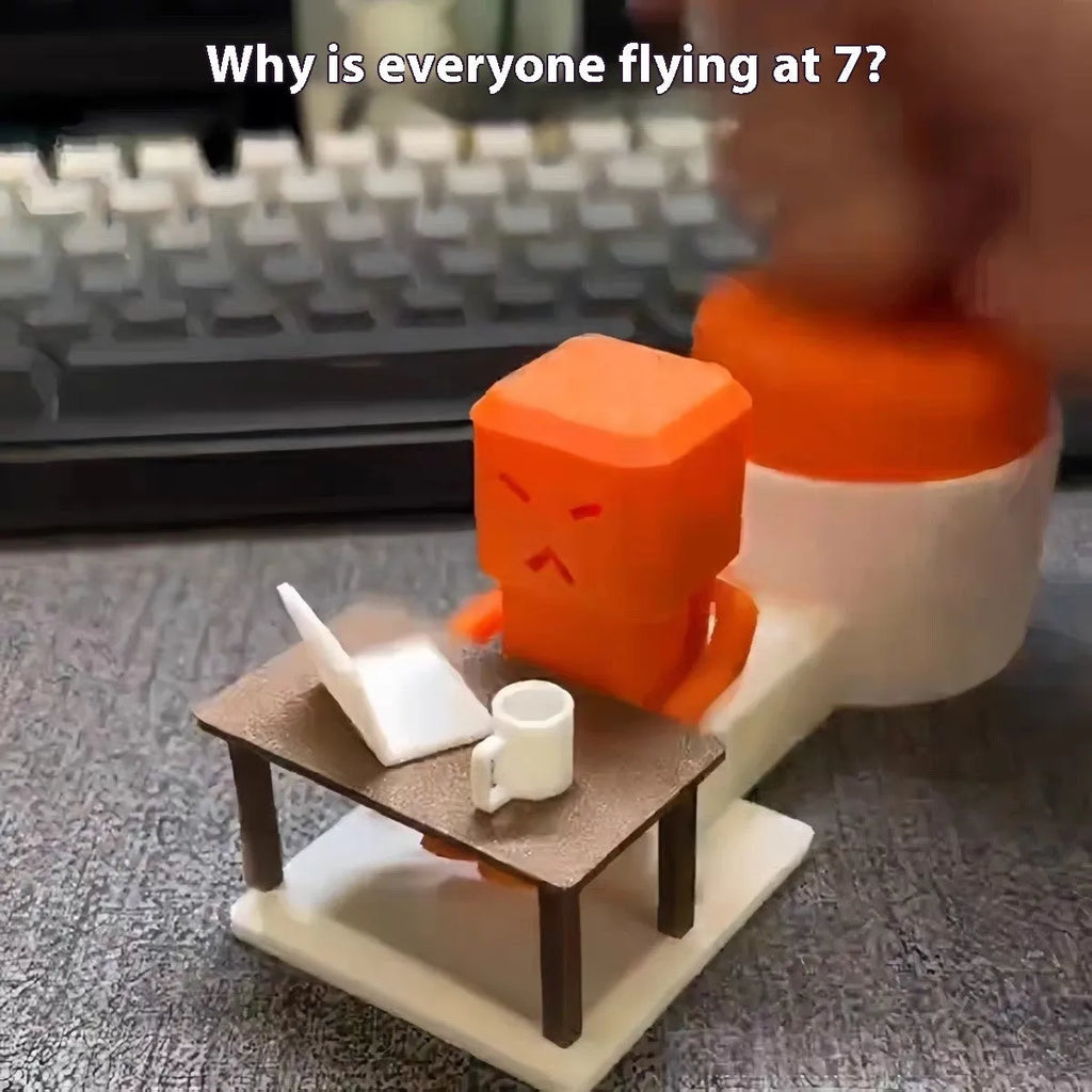 Orange plastic vent decompression toy on desk showing table turning mechanism