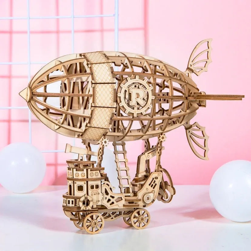 Wooden 3D puzzle model of a balloon assembled from pre-cut wood pieces on a light background