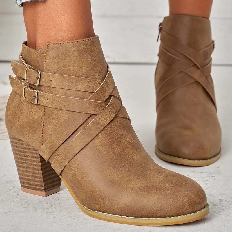 Women's grey short boot with 7cm heel, side zipper, and belt buckle detail on a rubber sole.