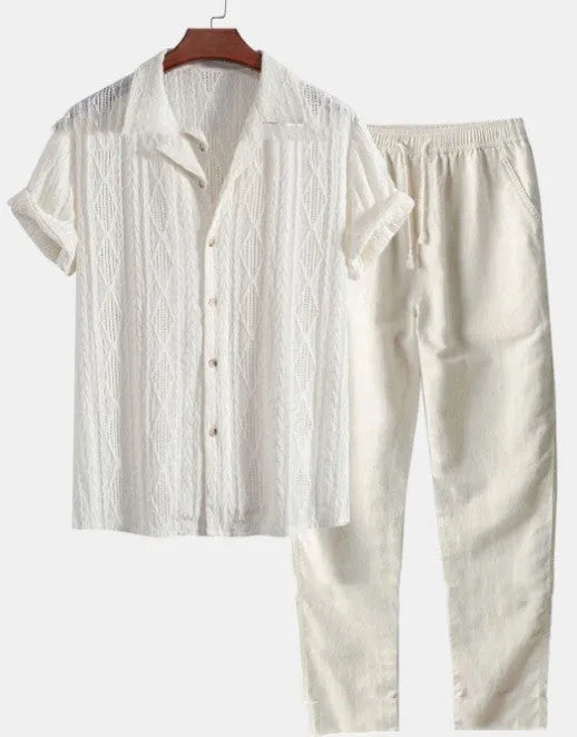 Man wearing a loose light blue short sleeve shirt and matching trousers, a summer casual suit