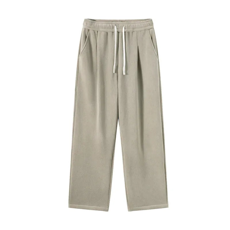 Men's apricot double-sided polar fleece winter trousers with a loose fit and drawstring waistband on a hanger.