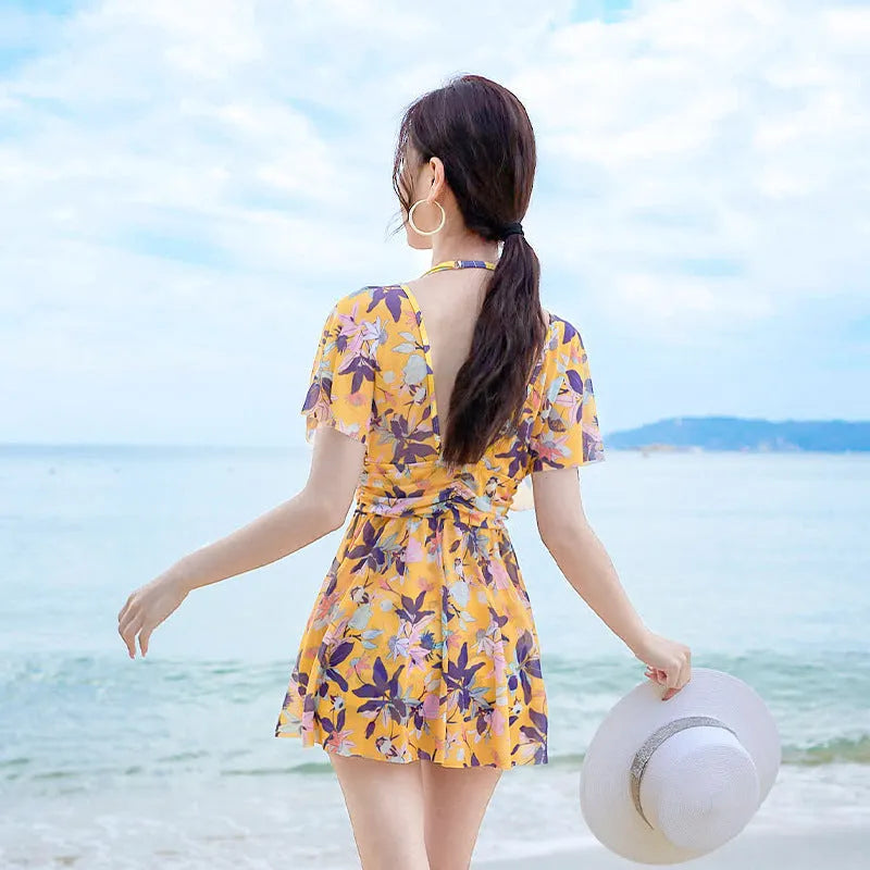Women's yellow floral one-piece swimsuit made from polyester with full coverage design