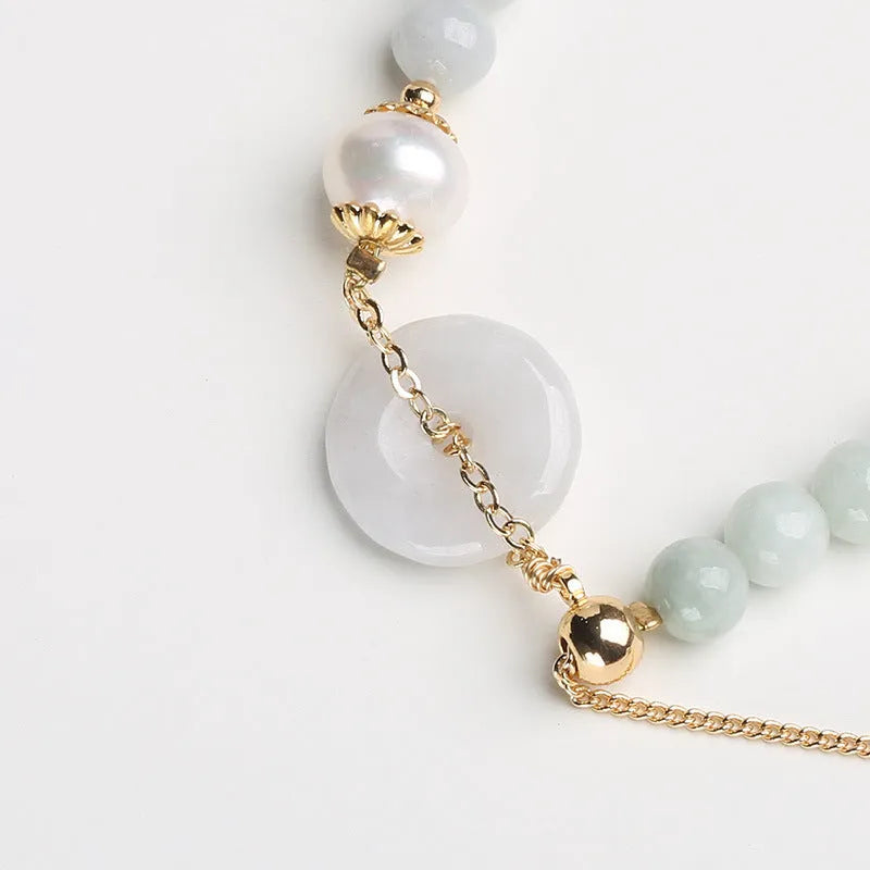 Traditional jade bracelet with peace buckle charm and pearl accents for women