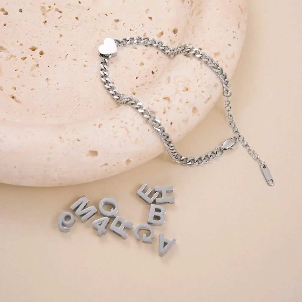 Gold and silver titanium steel necklaces with letter, number, and heart pendants on 40cm chains.