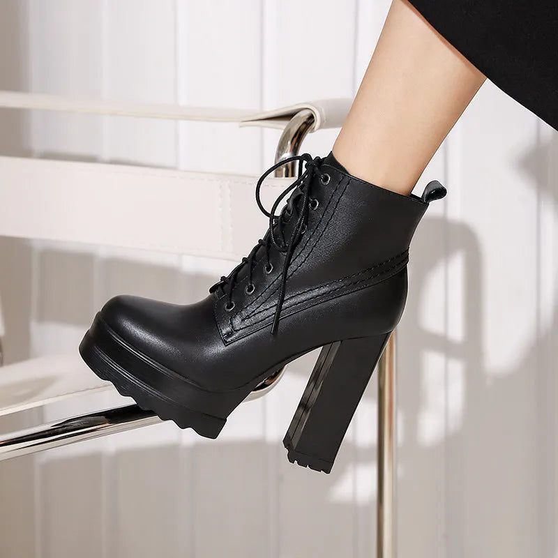 Women's chunky heel waterproof platform high heel boots in black cowhide leather with side zipper and round toe.