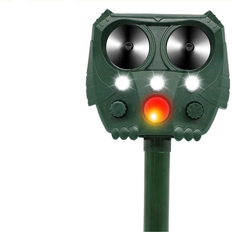 Green solar-powered ultrasonic dog repeller with LED lights for outdoor animal deterrent.
