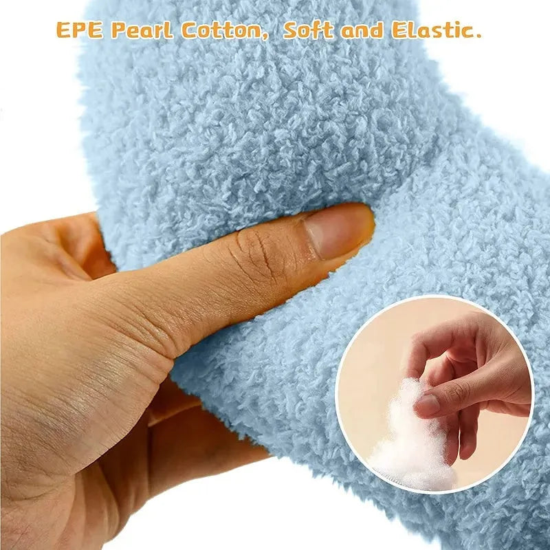Small half-donut shaped pet pillow in blue faux fur, showing quilted texture and plush filling.