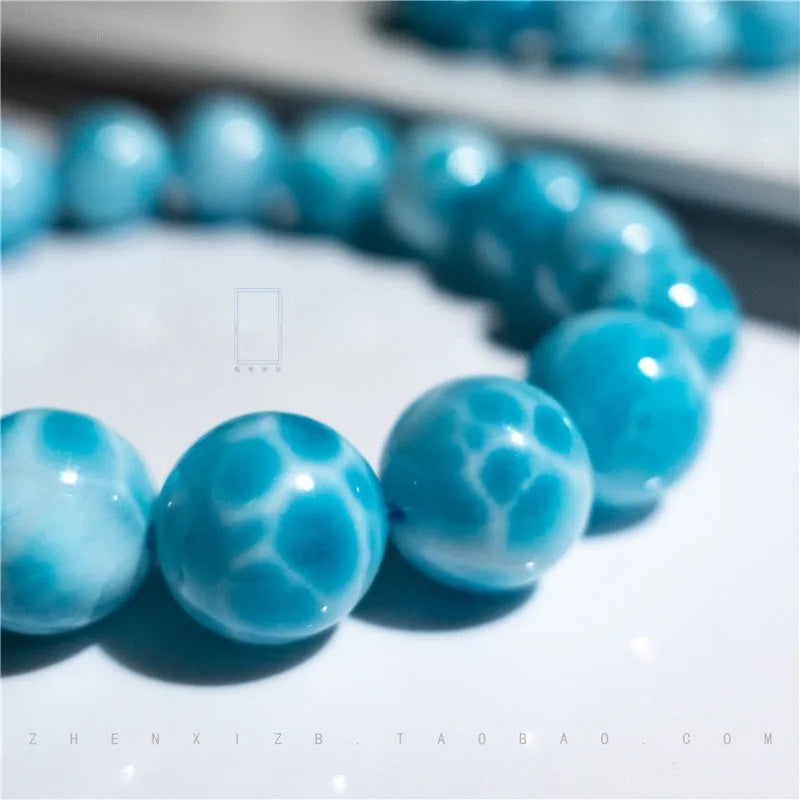 Blue handmade Bodhi bracelet with sea-pattern crystal stone and pearl accent in Maillard style.